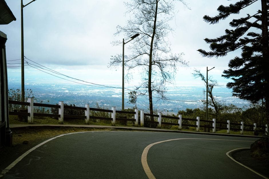 A serene view of a winding road overlooking Tagaytay City's vast landscape in the Philippines. (Photo by Justin Rieta on Pexels)
