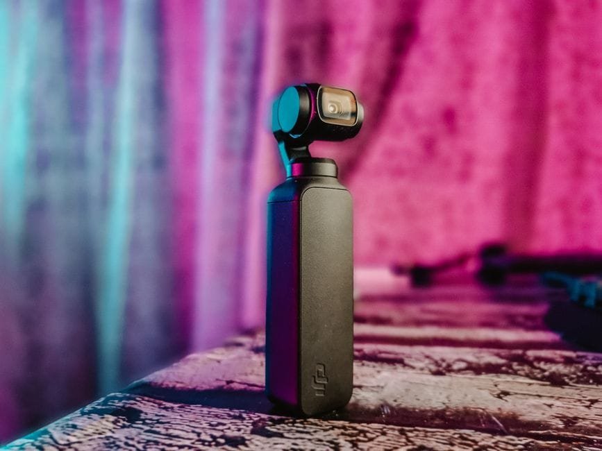 Stylish portable camera stabilizer set against a colorful vibrant background indoors. (Photo by Robert Nagy on Pexels)