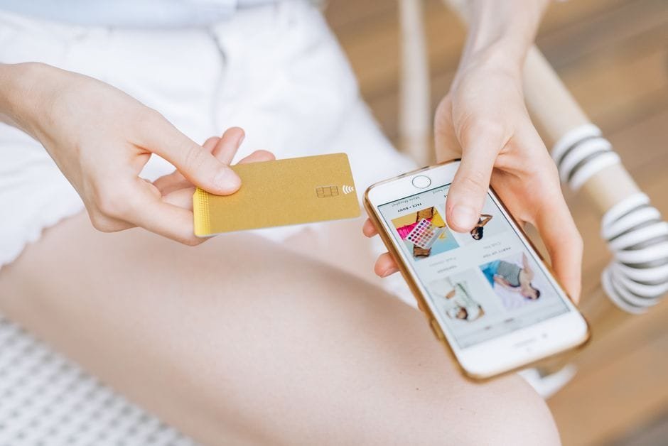 Close-up of a woman holding a smartphone and credit card for online shopping. Modern e-commerce concept. (Photo by Leeloo The First on Pexels)