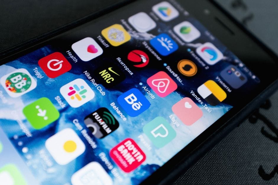 Detailed view of smartphone displaying multiple app icons on screen, highlighting technology use. (Photo by ready made on Pexels)