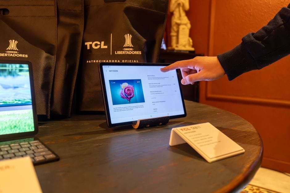 Close-up of a person using a touchscreen tablet during a tech conference, highlighting modern connectivity. (Photo by Matheus Bertelli on Pexels)