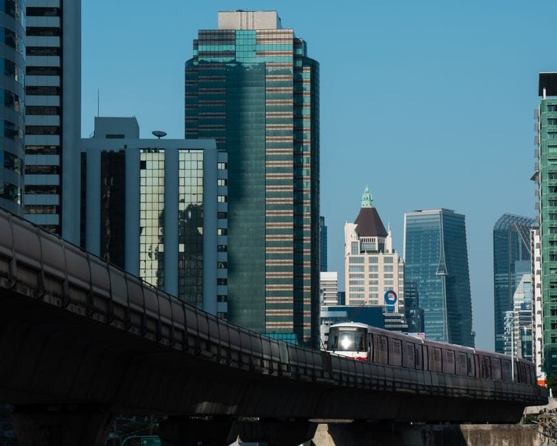 MRT train passing through Bangkok's modern skyline, showcasing skyscrapers and urban architecture. (Photo by Zaonar Saizainalin on Pexels)