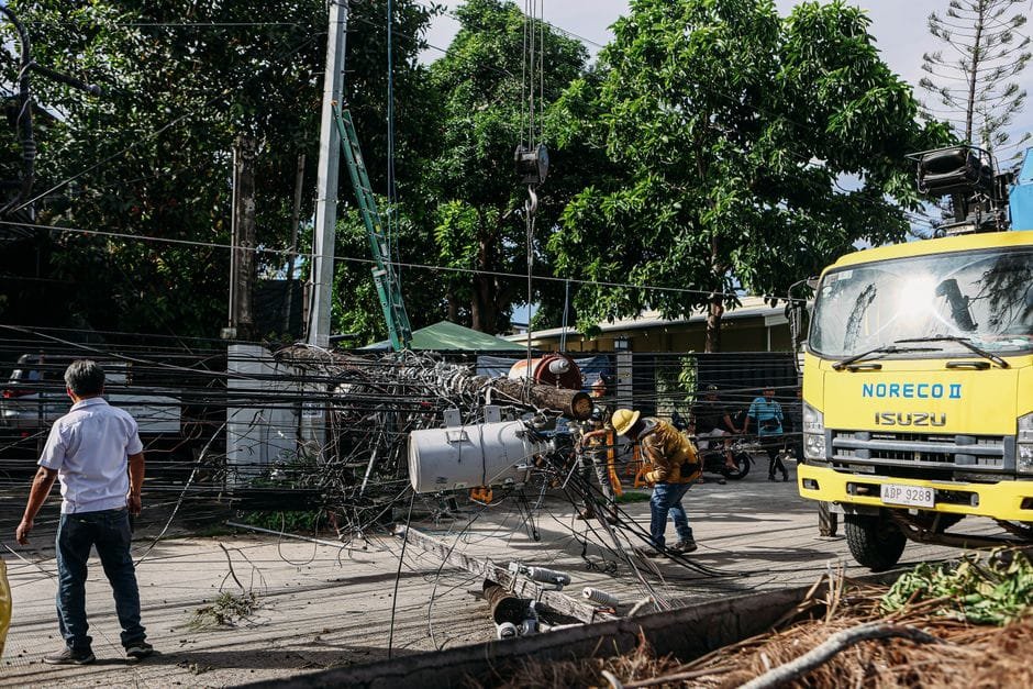 Team of workers in hard hats repairing electrical lines from a fallen pole after an accident. (Photo by Denniz Futalan on Pexels)