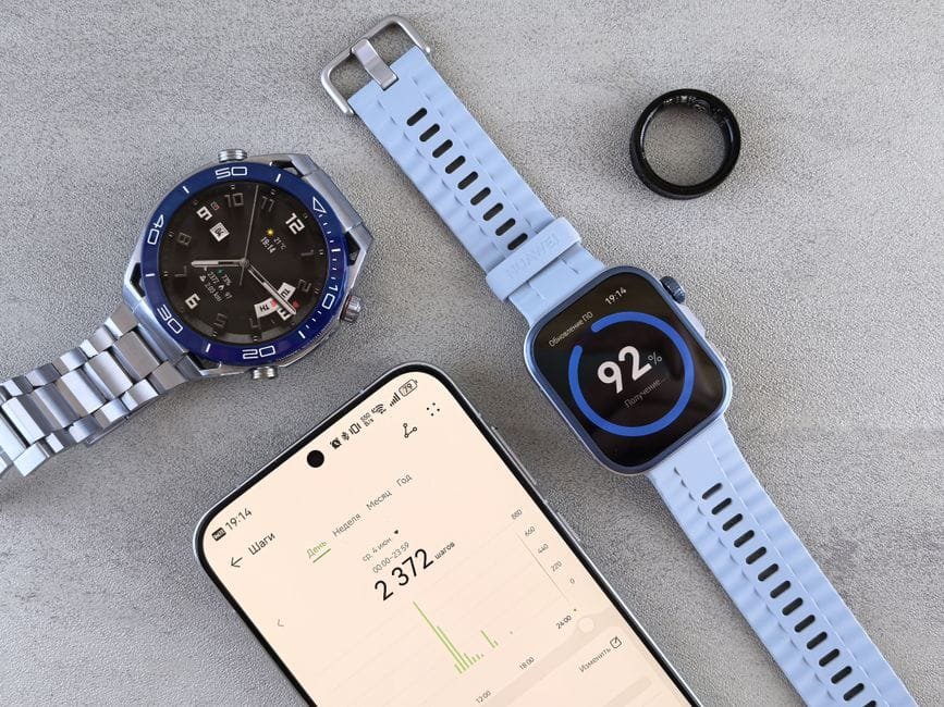 Smartwatch, ring tracker, and smartphone displaying fitness data on a gray surface. (Photo by Andrey Matveev on Pexels)