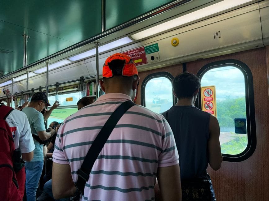 A view inside a Metro Manila train with passengers standing, capturing the urban commuter experience. (Photo by Primosky Studio on Pexels)