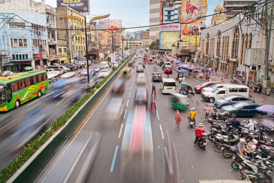 Vibrant daytime traffic in Manila city, showcasing bustling urban life and fast-moving vehicles. (Photo by Joseph Robert M on Pexels)