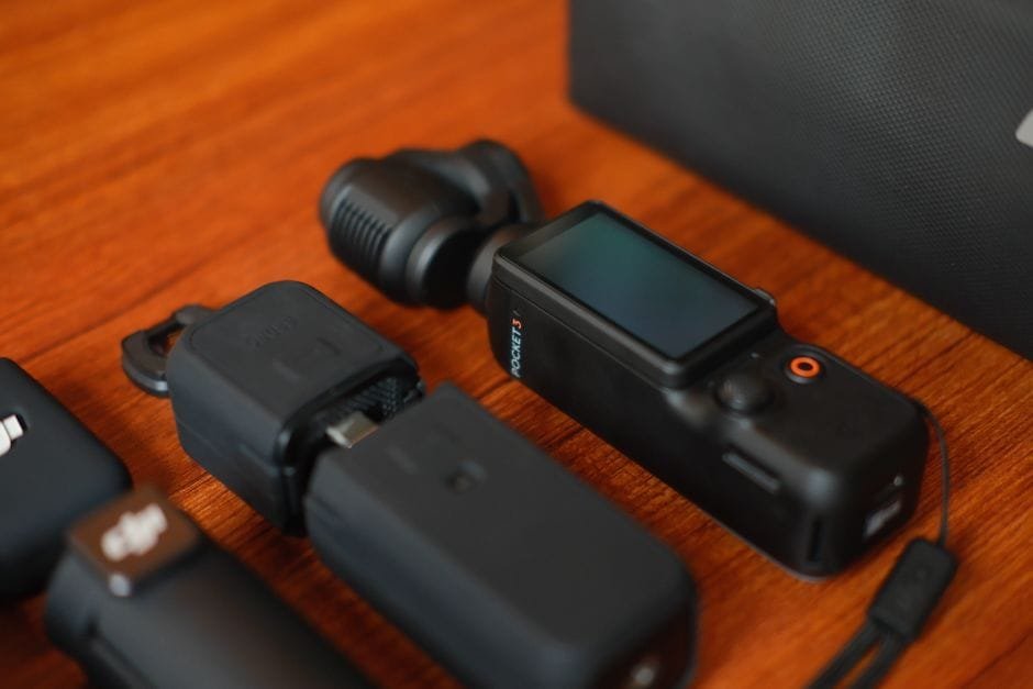 Compact camera gear and accessories neatly arranged on a wooden surface, ideal for travel and filming. (Photo by Paul De Vota on Pexels)