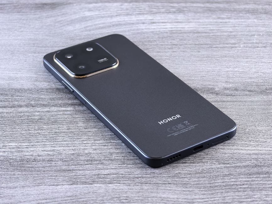 Close-up of a modern smartphone with a sleek design on a wooden surface. (Photo by Andrey Matveev on Pexels)