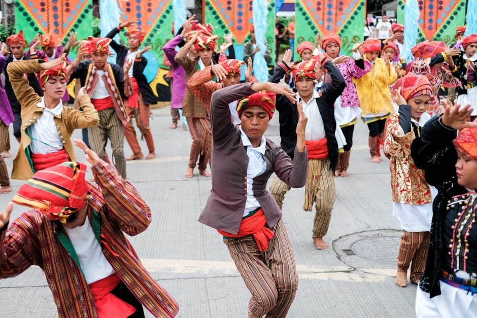 Vibrant street festival in Davao City showcasing traditional cultural dance and attire. (Photo by Brendo Boyose on Pexels)
