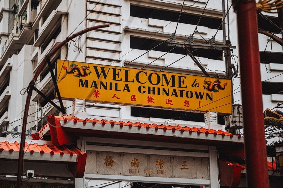 Bright yellow welcome sign at historic Manila Chinatown, featuring traditional architectural elements. (Photo by Nothing Ahead on Pexels)