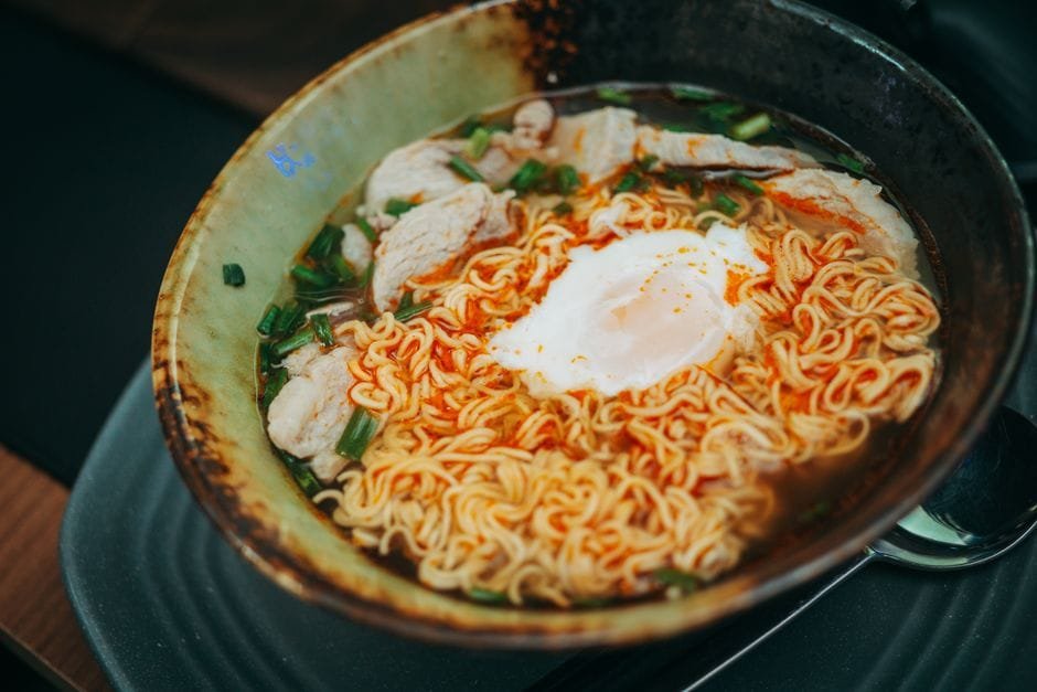 A savory bowl of ramen with poached egg, chicken, and green onions, perfect for a comforting meal. (Photo by FOX ^.ᆽ.^= ∫ on Pexels)