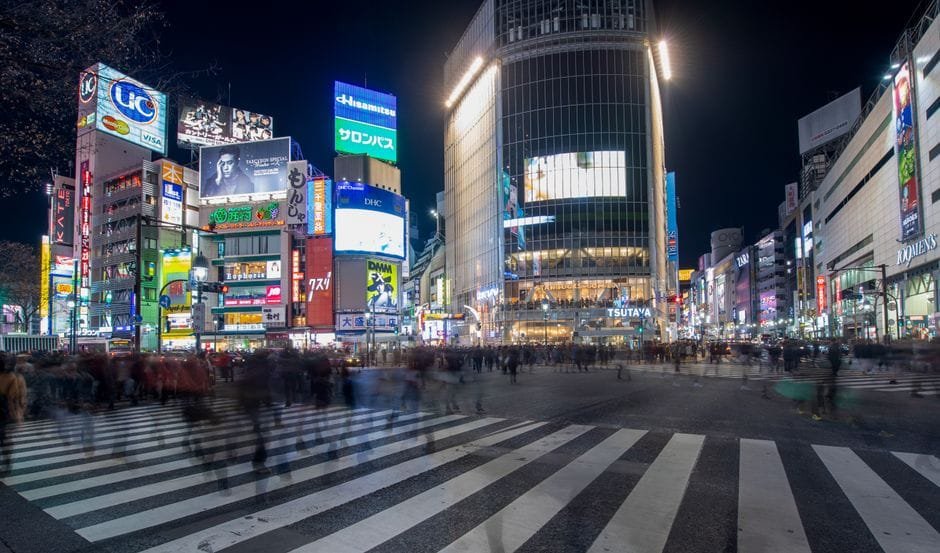 Experience the vibrant energy of Shibuya Crossing in Tokyo at night, with bustling crowds and colorful neon lights. (Photo by Margo Evardson on Pexels)