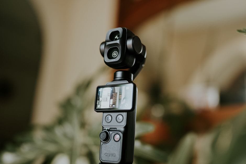 Close-up of a modern camera gimbal stabilizer with digital display, indoors. (Photo by Amar  Preciado on Pexels)